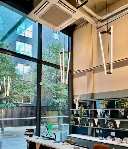 Floor to ceiling glass entrance with pendant lighting